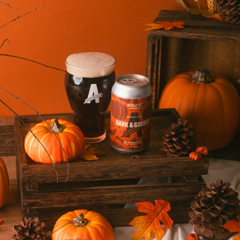 a can and a glass of dark&gourdy surrounded by pumpiking sna maple leaves