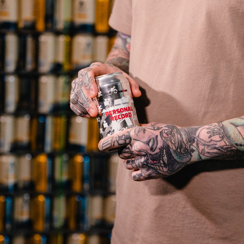 a personl holding a can of personal record IPA