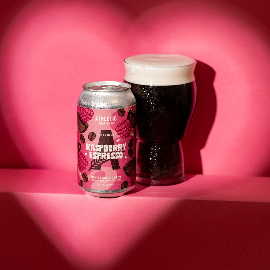 Raspberry espresso can and a glass of the extra dark beer in a hear shapped scnario 