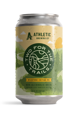 Condensation-covered can of Athletic Brewing Two for The Trails Milestone Edition IPA. The label features a stylized green forest landscape.