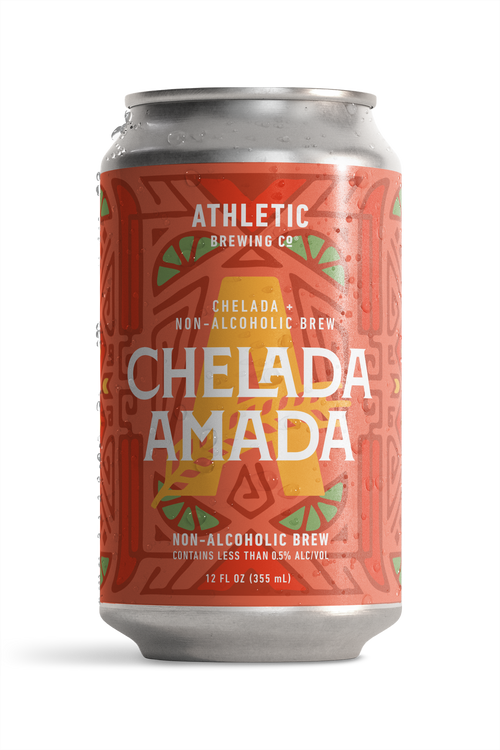 12 fl oz can of Athletic Brewing Chelada Amada non-alcoholic brew on a white background. The can features a coral-red label with a bold geometric pattern, lime slice illustrations, a large gold “A,” and the product name “Chelada Amada” in white lettering. Condensation droplets cover the can, emphasizing a cold, refreshing beverage.